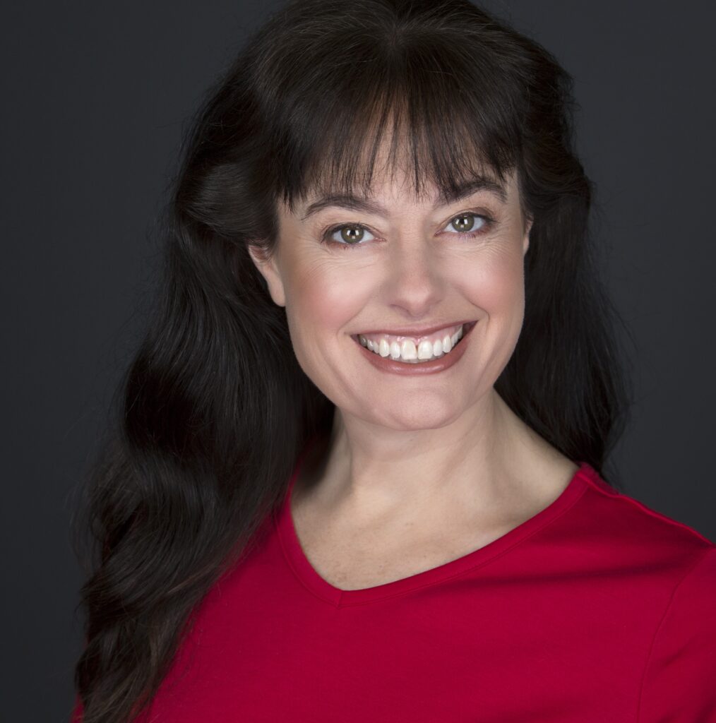 Headshot of Dr. Meagan Grega smiling wearing a red shirt